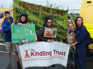 Kindling team with fracking banner